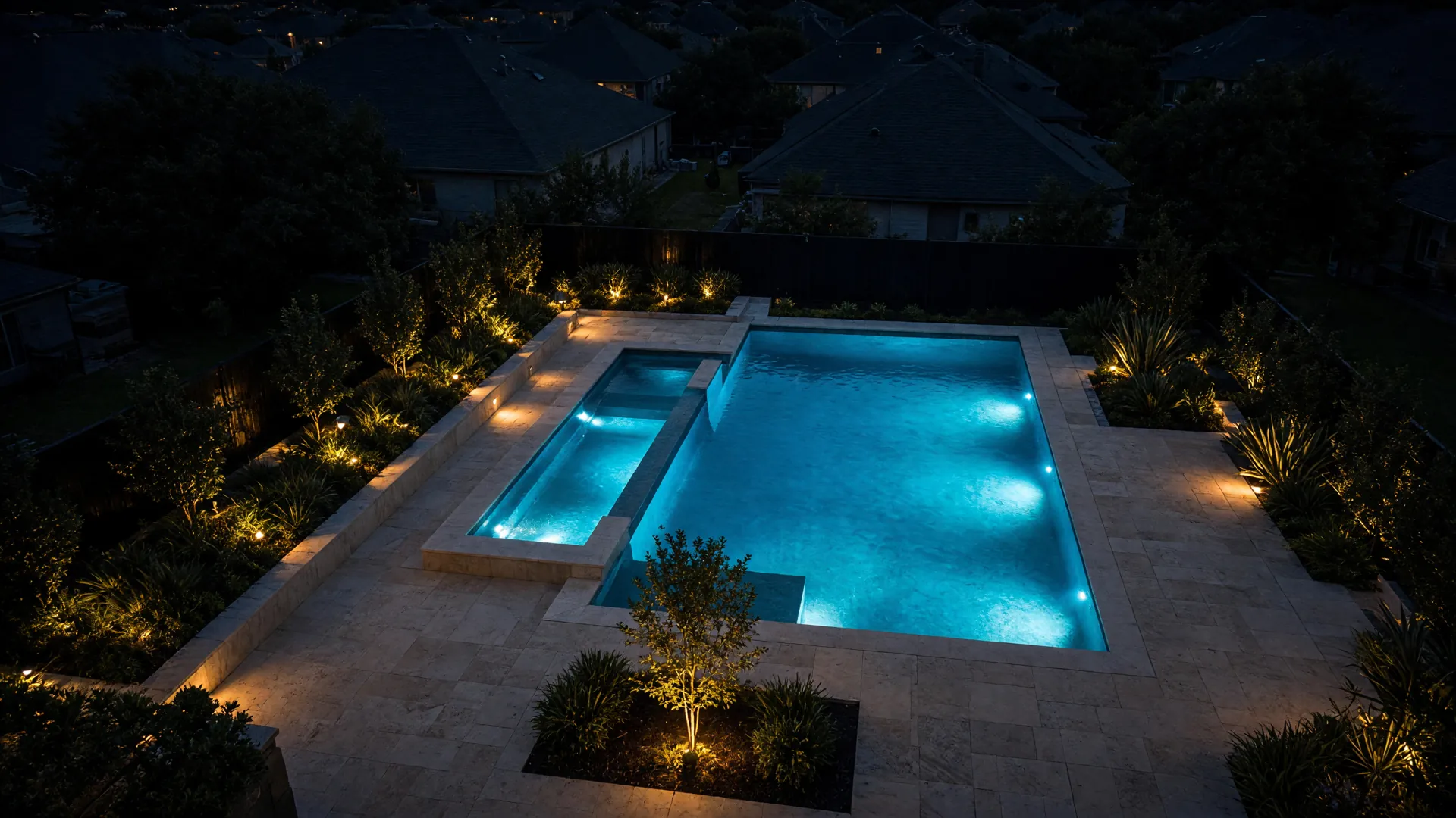 A newly finished backyard pool glowing at dusk